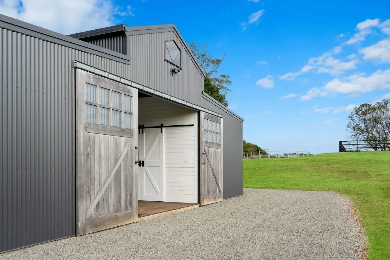 A barn exterior with timber sliding doors